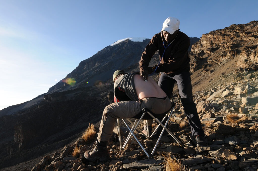 A photo of someone getting a daily check from a guide